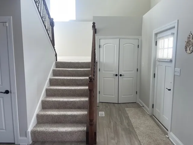 a view of an entryway with wooden floor