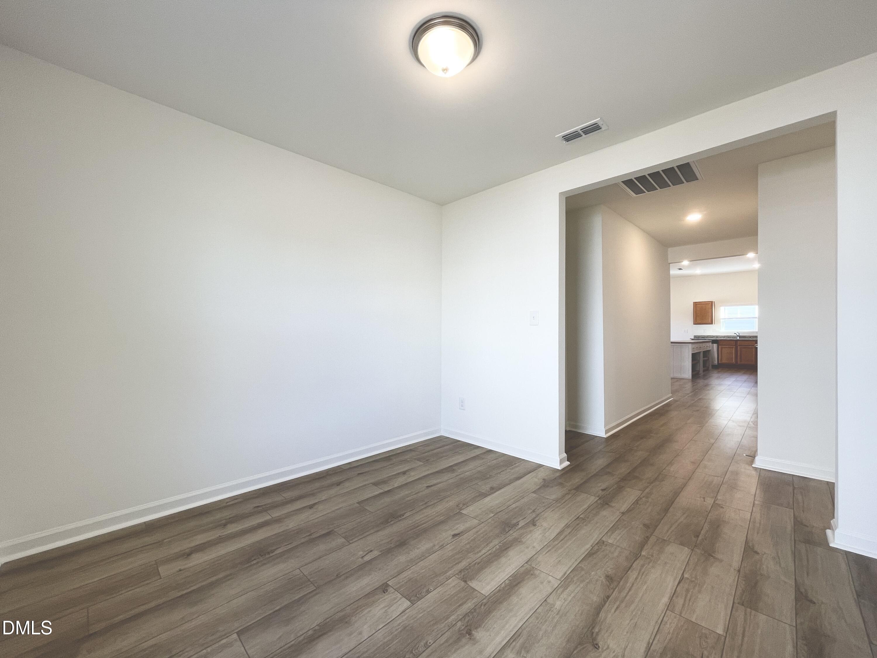 6117 Oak Psge Drive Raleigh, NC 27603 - Photo 11 of 25 a view of a hallway with wooden floor