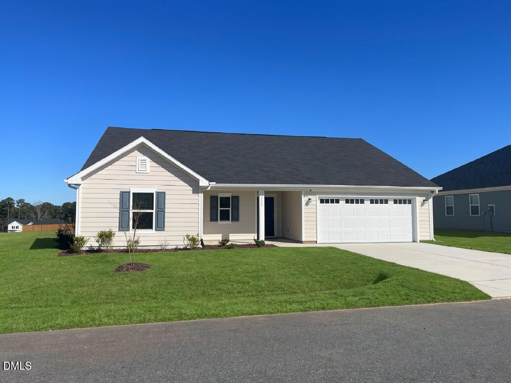 6117 Oak Psge Drive Raleigh, NC 27603 - Photo 2 of 25 a front view of a house with a yard and garage