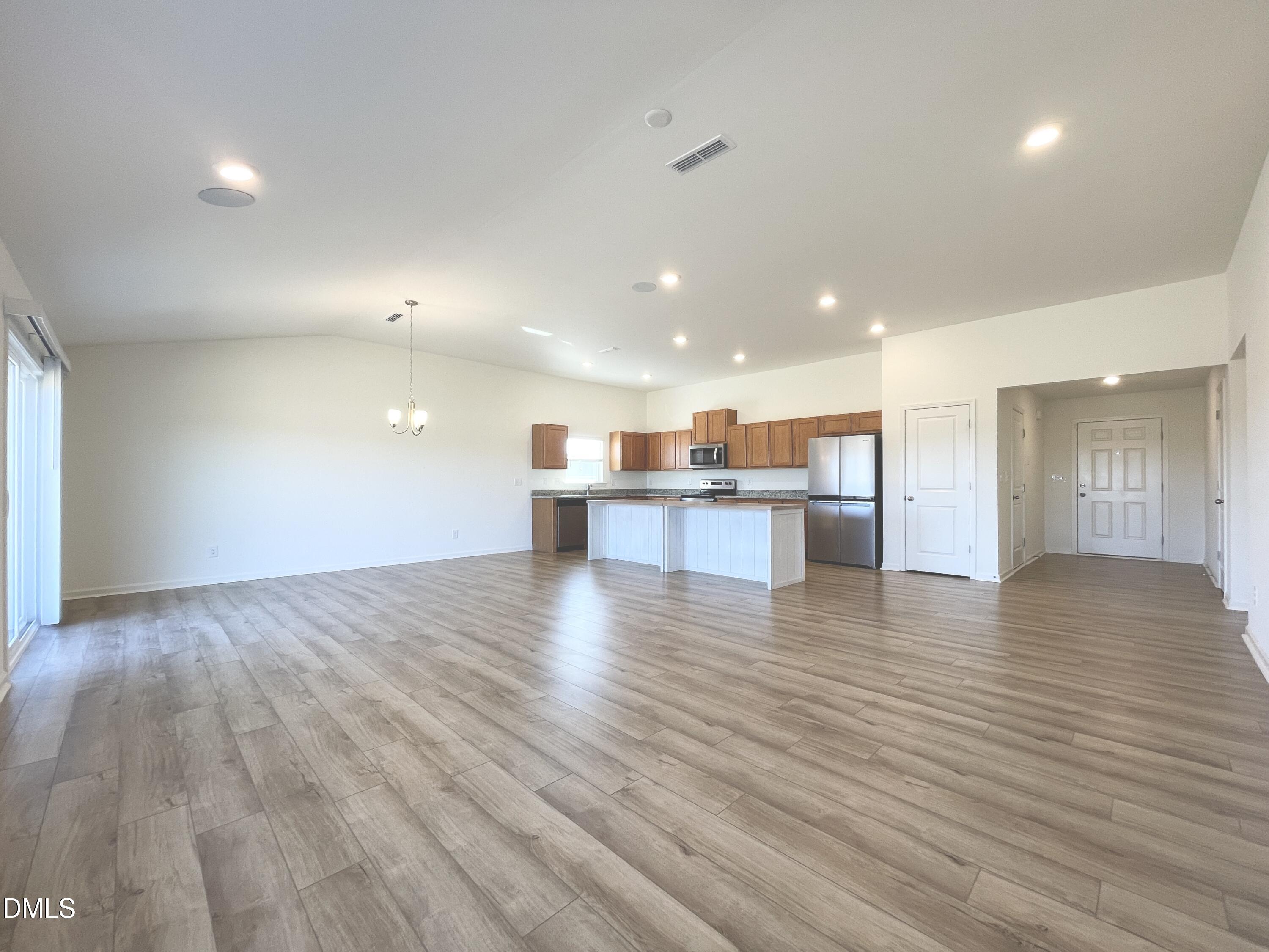 6117 Oak Psge Drive Raleigh, NC 27603 - Photo 4 of 25 a view of kitchen and a hallway with wooden floor