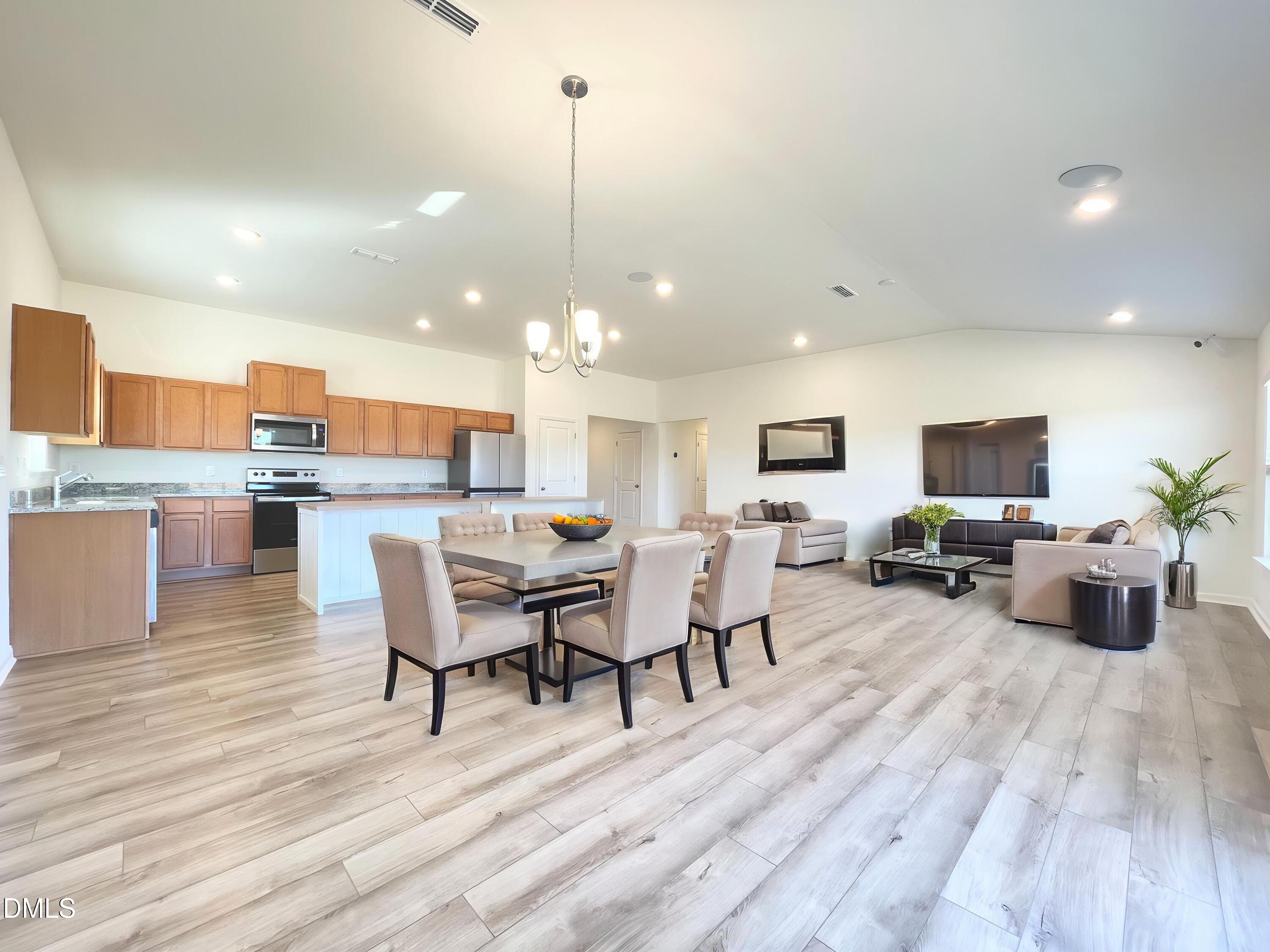 6117 Oak Psge Drive Raleigh, NC 27603 - Photo 5 of 25 a view of a dining room with furniture wooden floor and chandelier