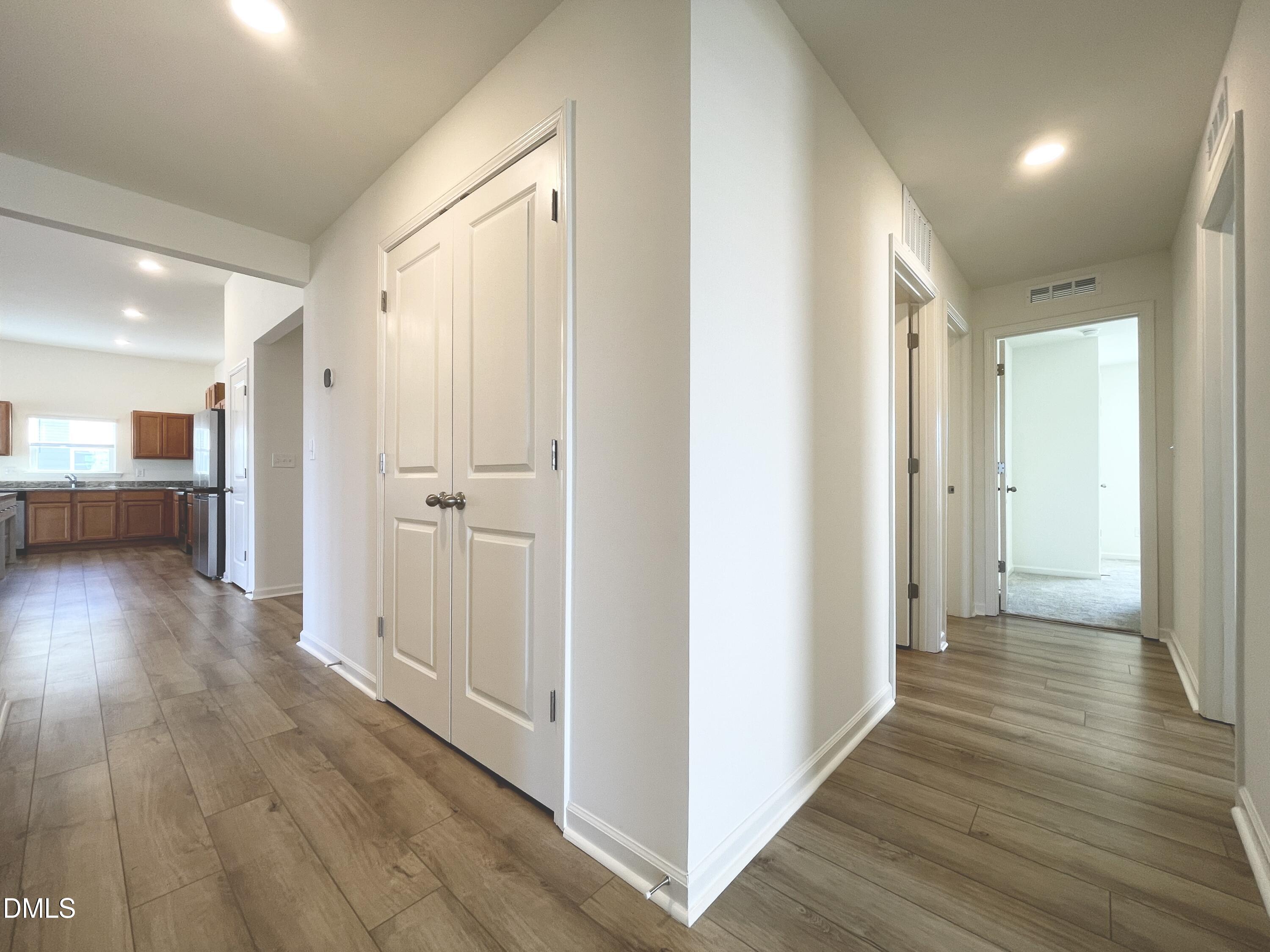 6117 Oak Psge Drive Raleigh, NC 27603 - Photo 9 of 25 a view of a hallway with wooden floor