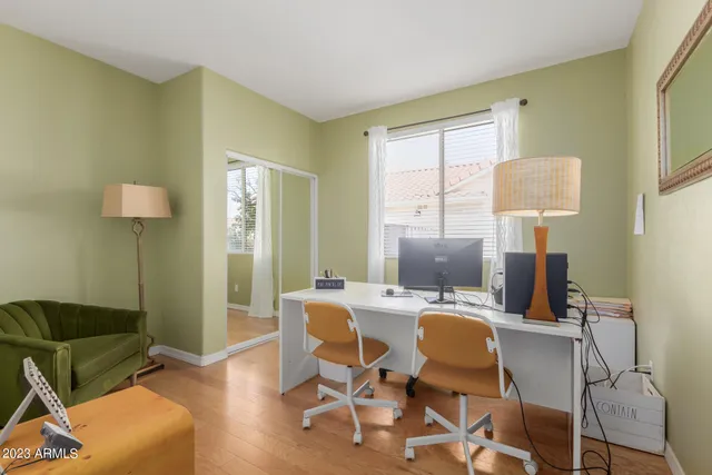 a view of a dining room with furniture and a window