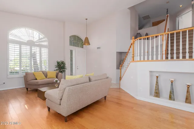 a living room with furniture window and wooden floor