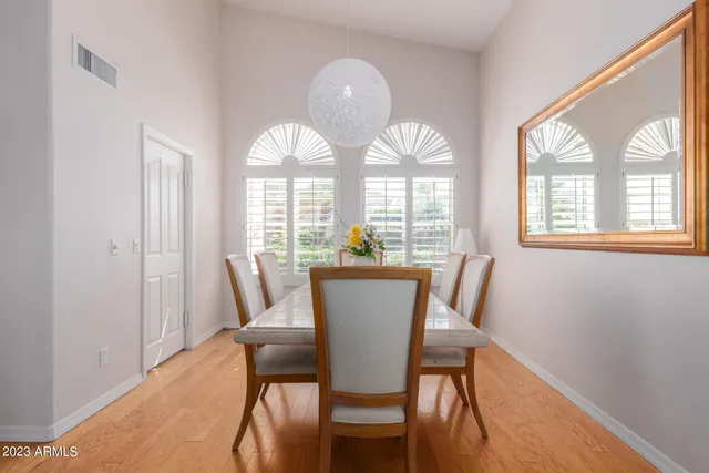 a view of a dining room with furniture a chandelier and wooden floor
