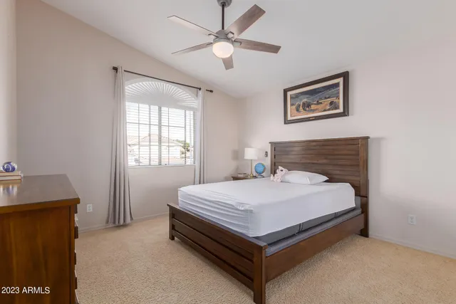 a bed sitting in a bedroom next to a window