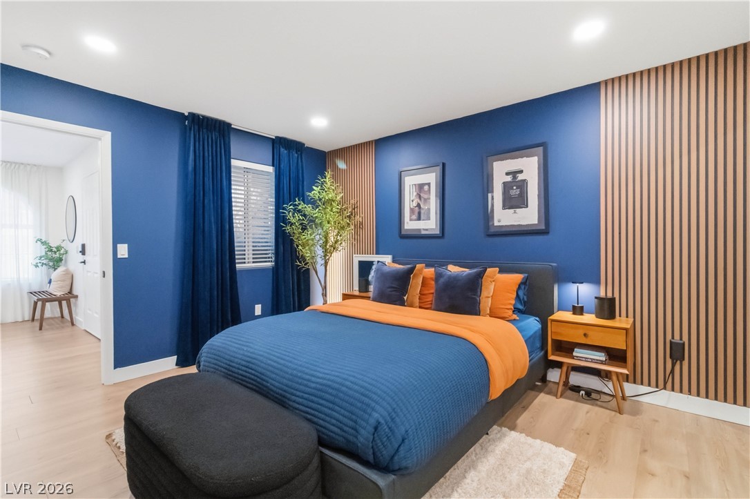 7950 West Flamingo Road, Unit 1180 Las Vegas, NV 89147 - Photo 16 of 26 Bold blue walls and a distinctive slatted accent wall define this inviting bedroom space.