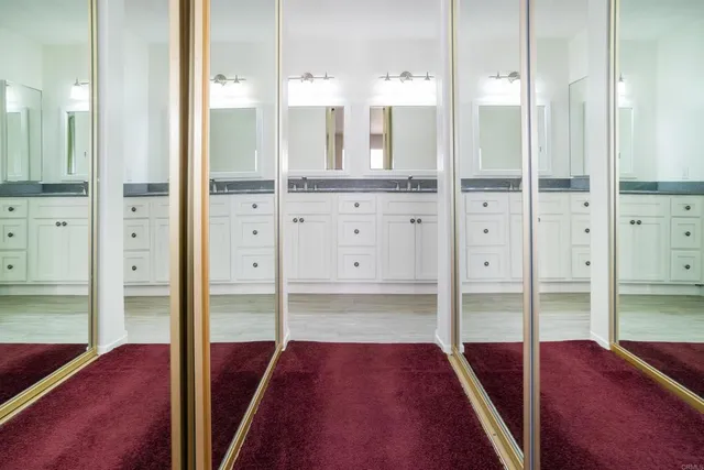 a bathroom with double sink and a mirror