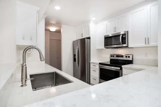 an empty room with a chandelier fan