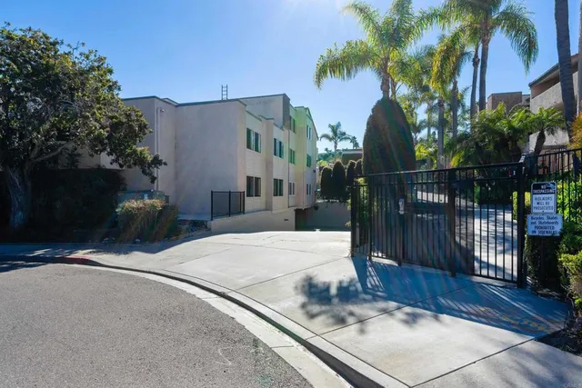 a bathroom with a granite countertop sink and a toilet