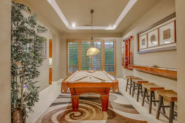 a bedroom with a bed a couch and a potted plant