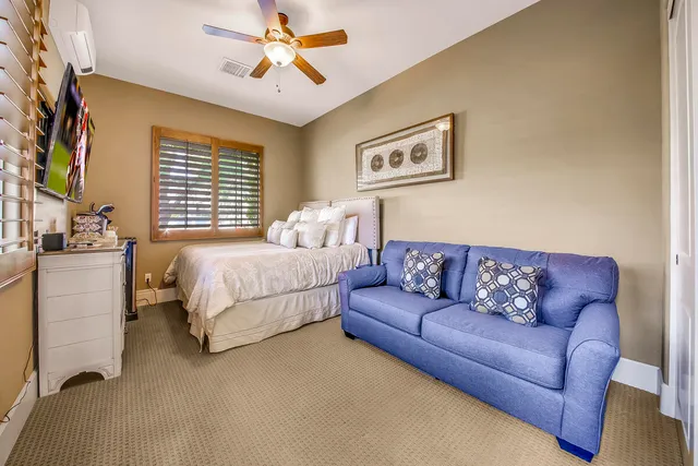 a bedroom with two beds and a chandelier