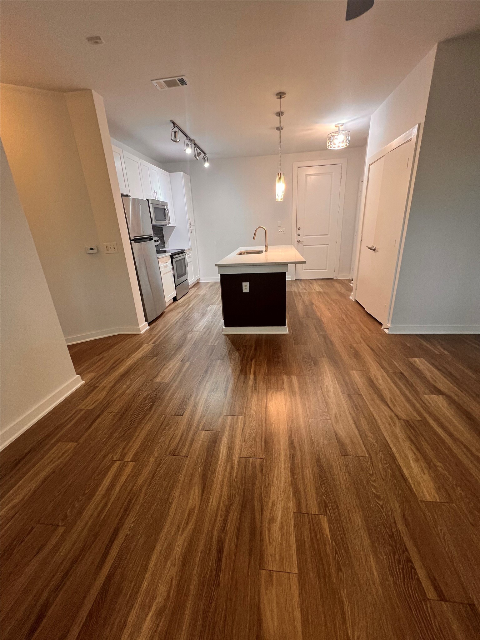 1900 Barton Springs Road, Unit 4041 Austin, TX 78704 - Photo 10 of 35 a view of a kitchen with a sink and wooden floor
