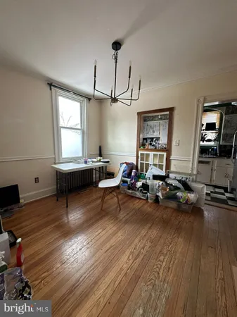 a living room with furniture gym equipment and a window