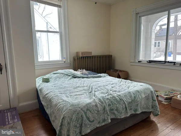 a bed sitting in a bedroom next to a window