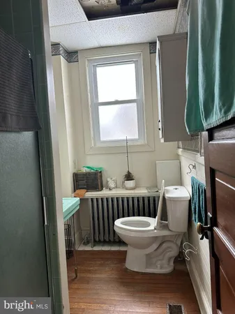 a bathroom with a toilet a sink and a mirror