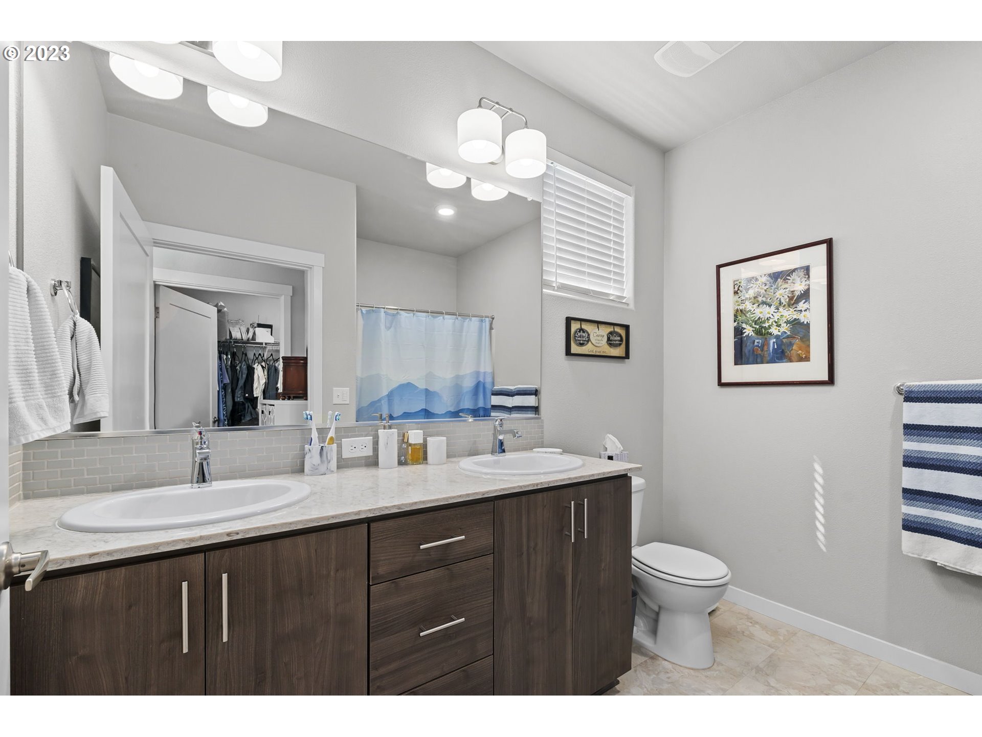 17051 Southwest Appledale Road, Unit 204 Beaverton, OR 97007 - Photo 17 of 23 a bathroom with a toilet sink and mirror