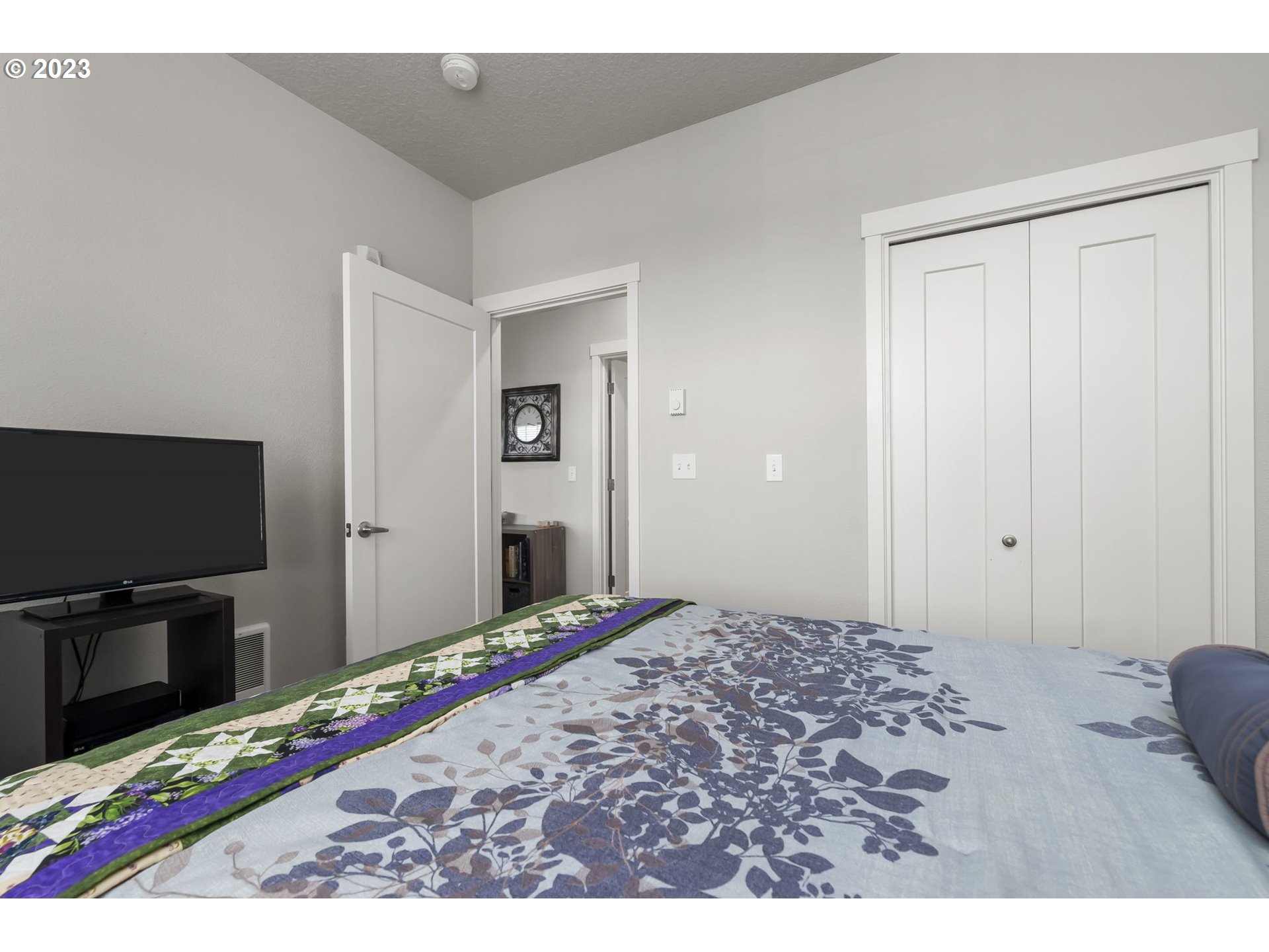 17051 Southwest Appledale Road, Unit 204 Beaverton, OR 97007 - Photo 4 of 23 a bedroom with a bed and a flat screen tv