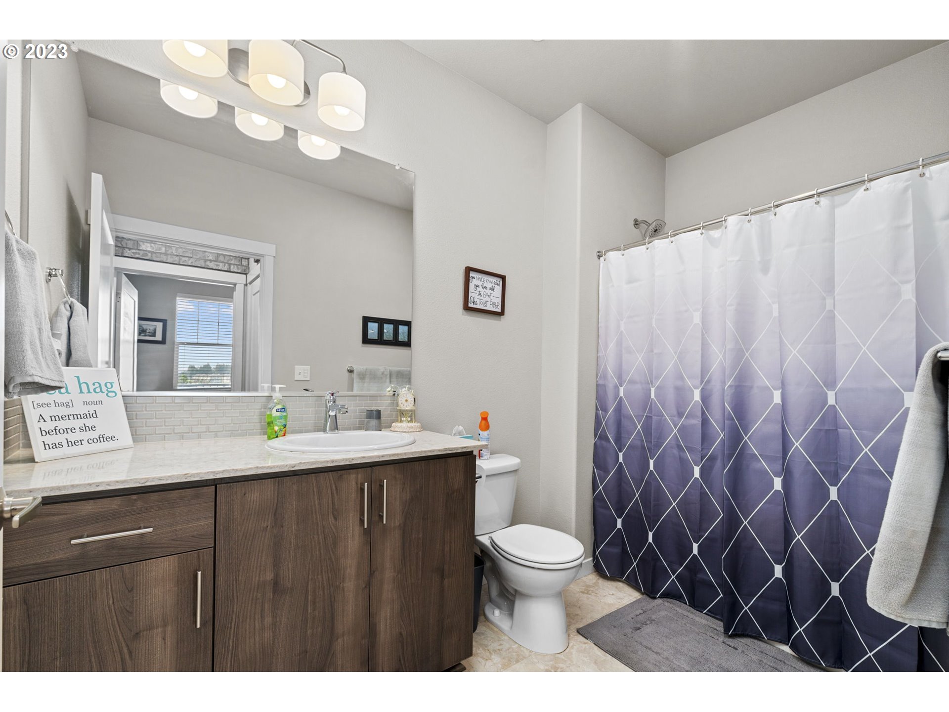 17051 Southwest Appledale Road, Unit 204 Beaverton, OR 97007 - Photo 6 of 23 a bathroom with a sink vanity mirror and toilet