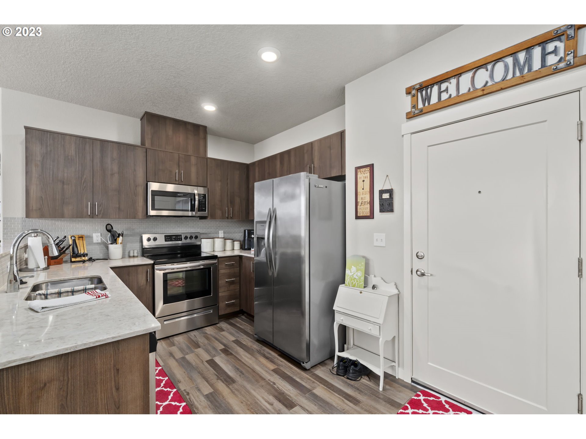 17051 Southwest Appledale Road, Unit 204 Beaverton, OR 97007 - Photo 7 of 23 a kitchen with kitchen island a refrigerator sink and stove