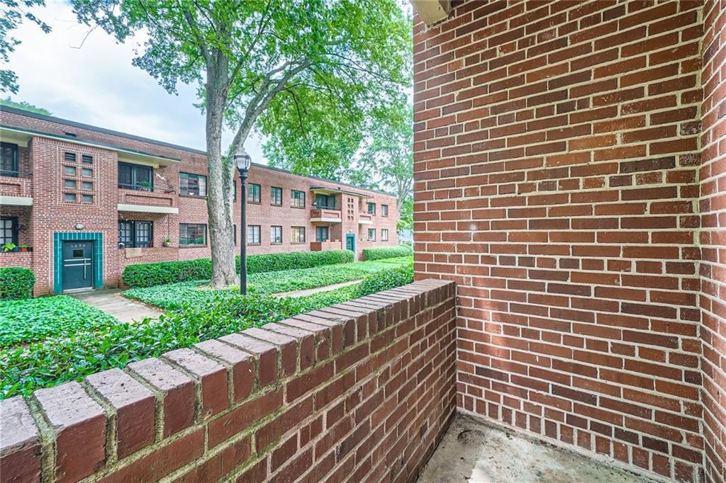1381 Normandy Drive Northeast, Unit 2 Atlanta, GA 30306 - Photo 11 of 12 a view of a brick building next to a yard