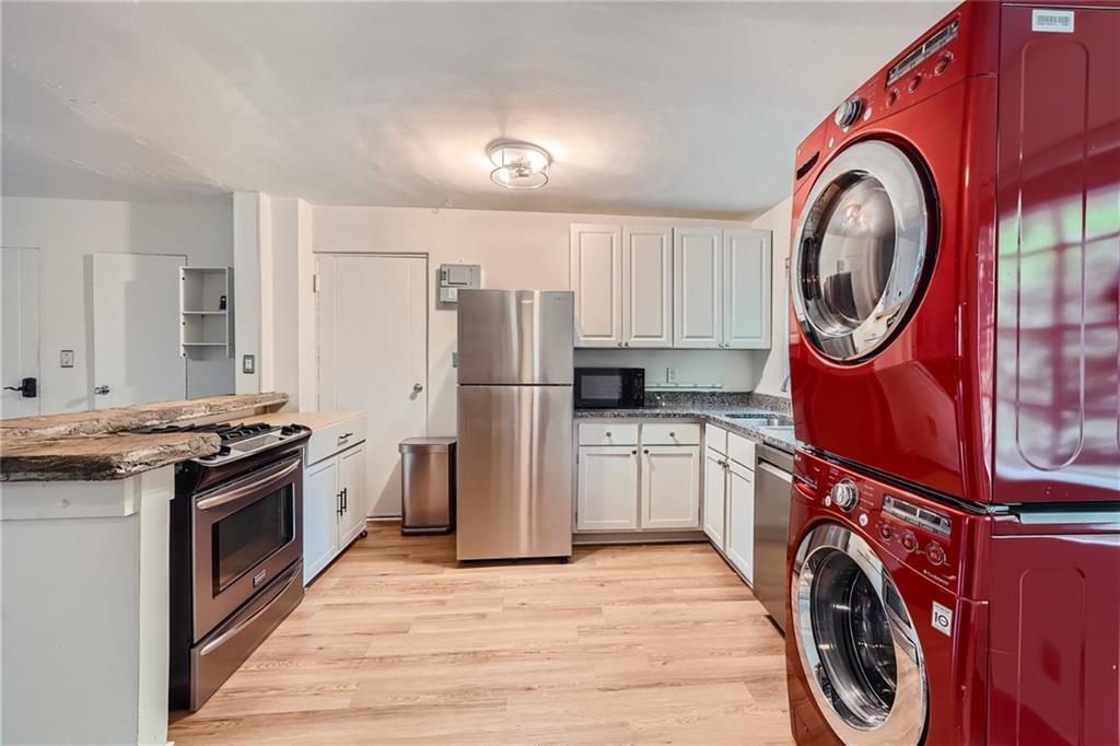 1381 Normandy Drive Northeast, Unit 2 Atlanta, GA 30306 - Photo 5 of 12 a kitchen with a stove top oven a sink and a refrigerator