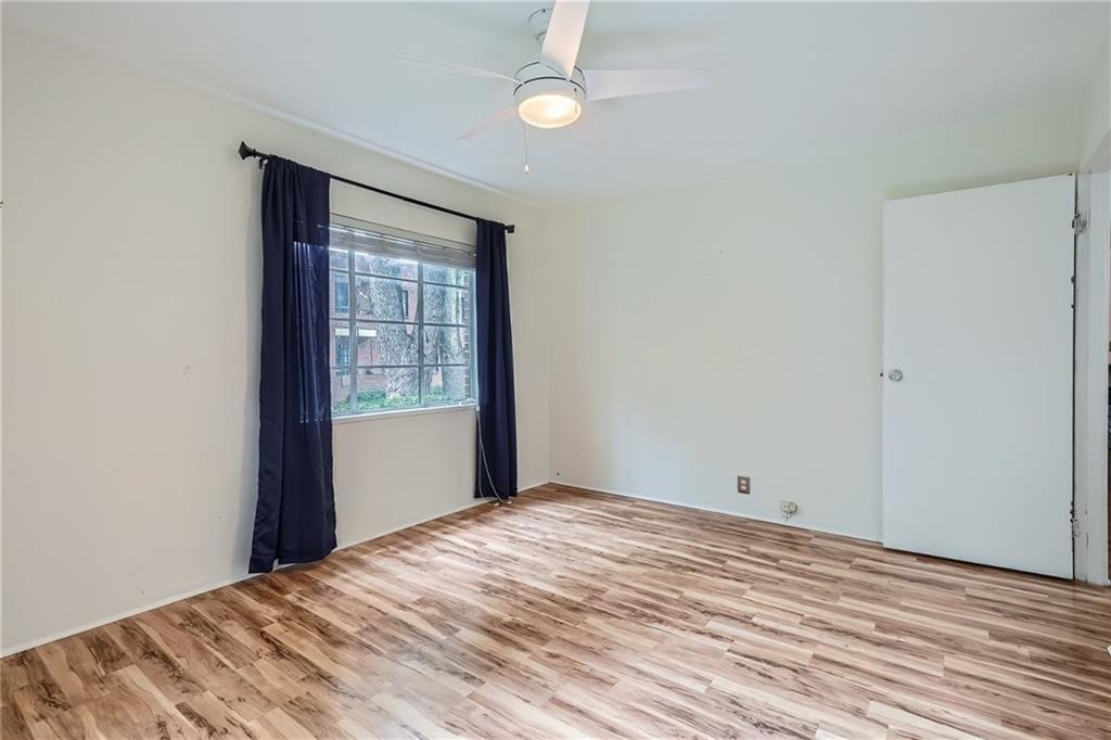 1381 Normandy Drive Northeast, Unit 2 Atlanta, GA 30306 - Photo 9 of 12 a view of an empty room with wooden floor and a window