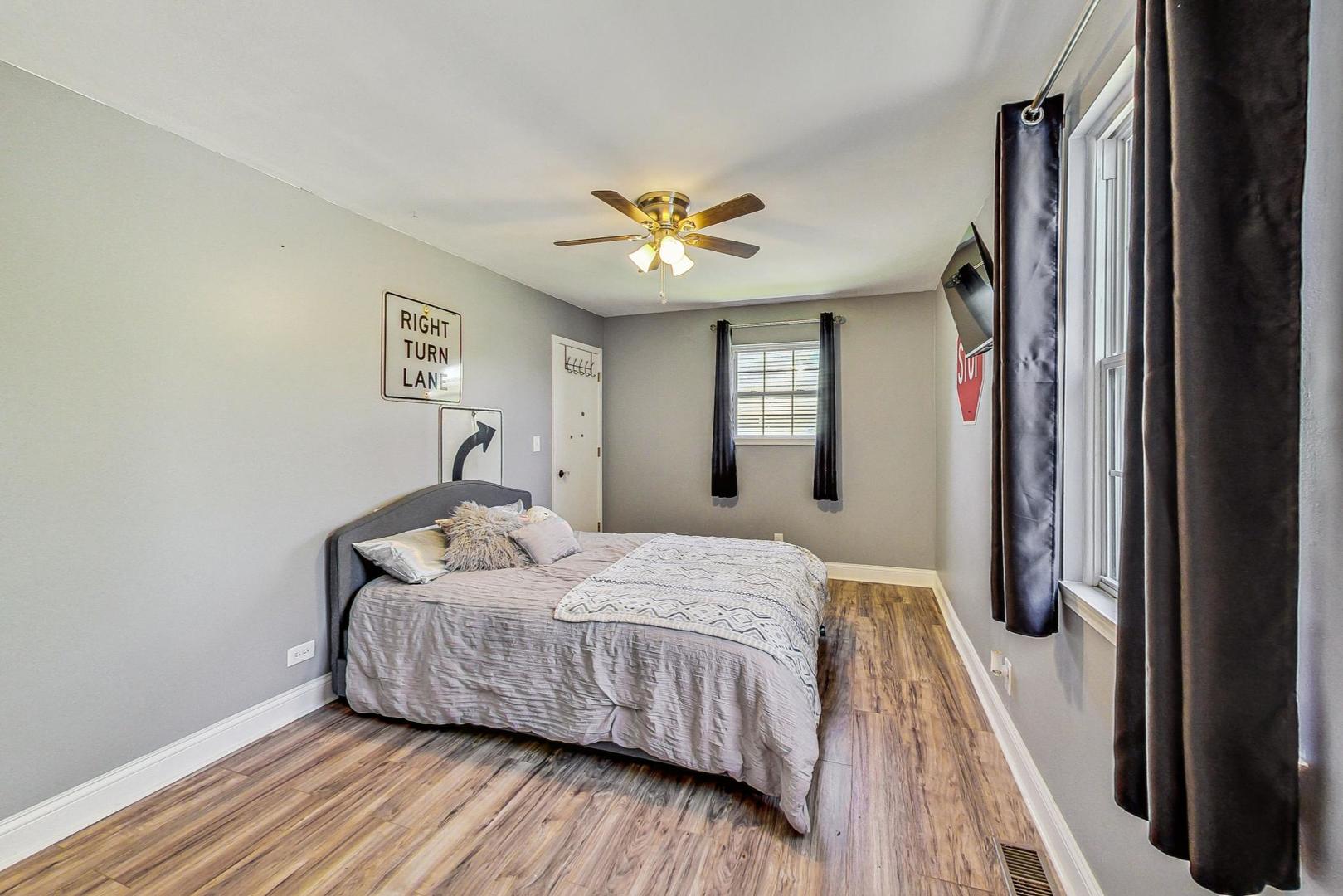 510 Porten Road Island Lake, IL 60042 - Photo 15 of 29 a bedroom with a bed and a chandelier