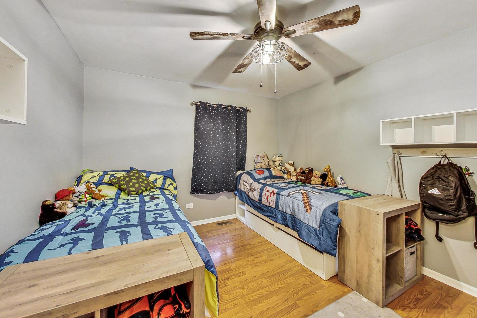 510 Porten Road Island Lake, IL 60042 - Photo 16 of 29 a bedroom with furniture and a chandelier