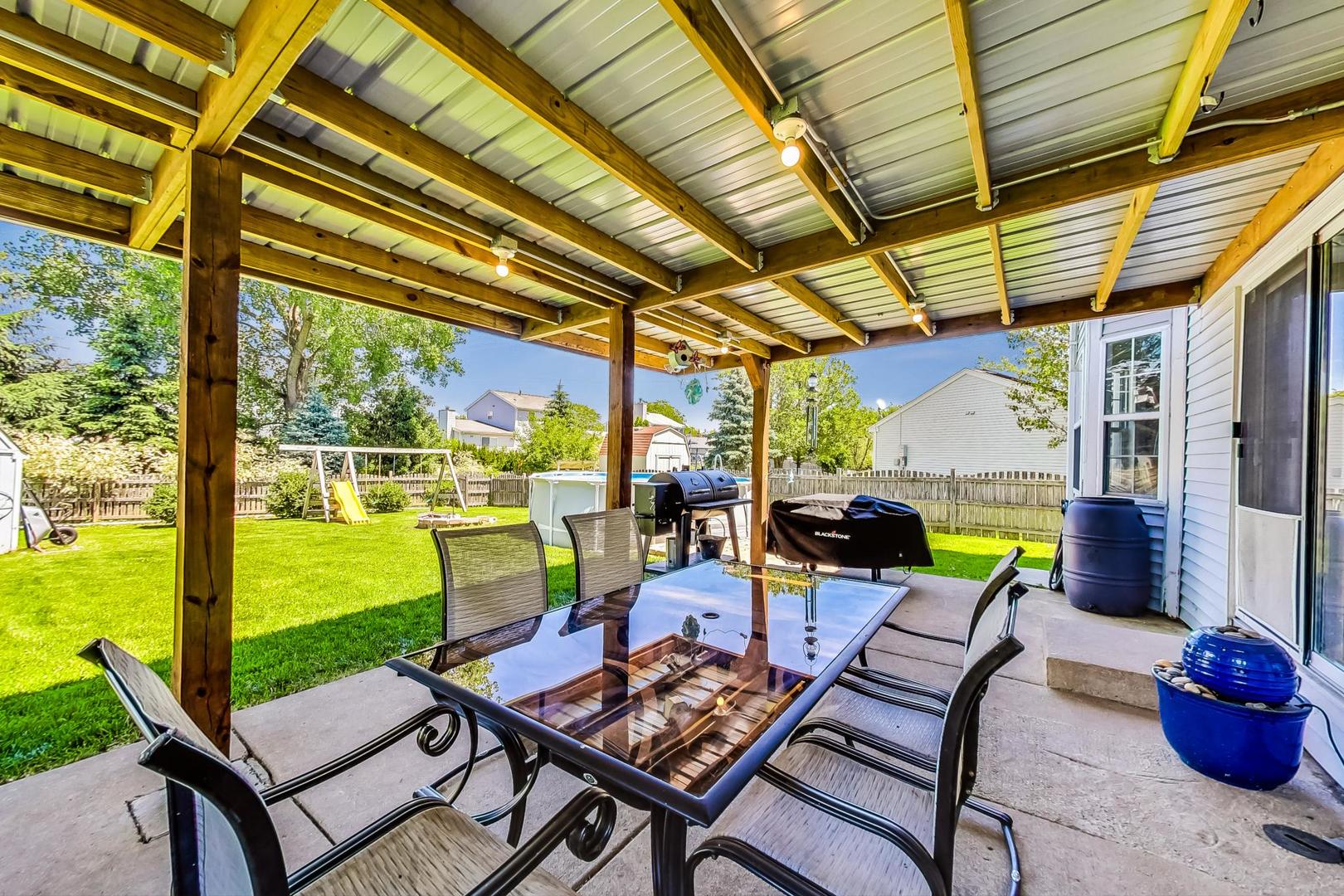 510 Porten Road Island Lake, IL 60042 - Photo 24 of 29 a view of a patio with a table chairs and a backyard