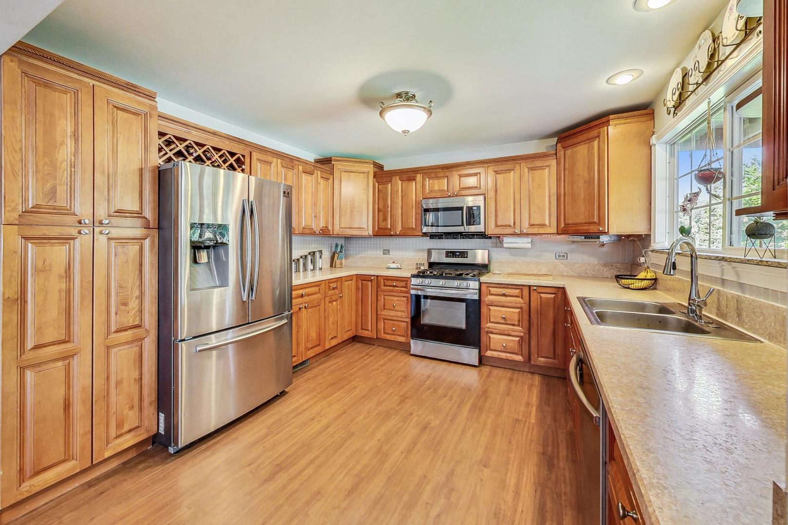 510 Porten Road Island Lake, IL 60042 - Photo 6 of 29 a kitchen with stainless steel appliances a refrigerator sink and cabinets