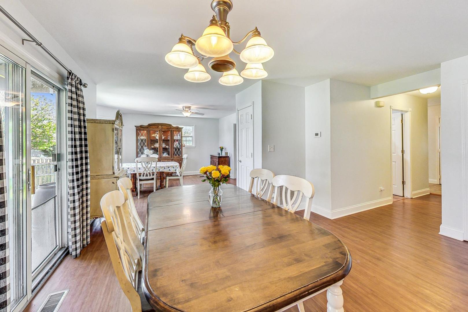 510 Porten Road Island Lake, IL 60042 - Photo 8 of 29 a dining room with wooden floor and chandelier