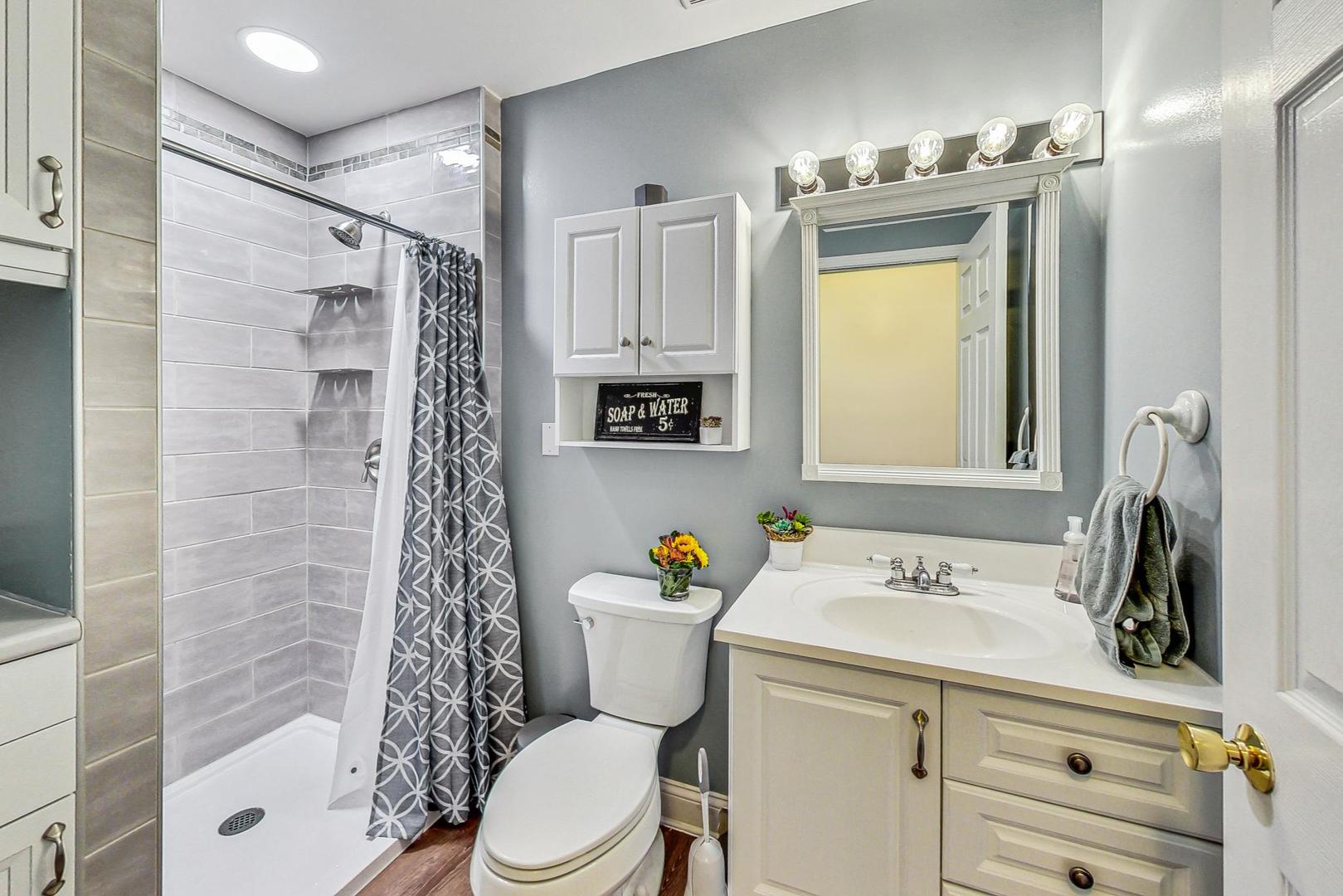 510 Porten Road Island Lake, IL 60042 - Photo 9 of 29 a bathroom with a sink toilet and shower