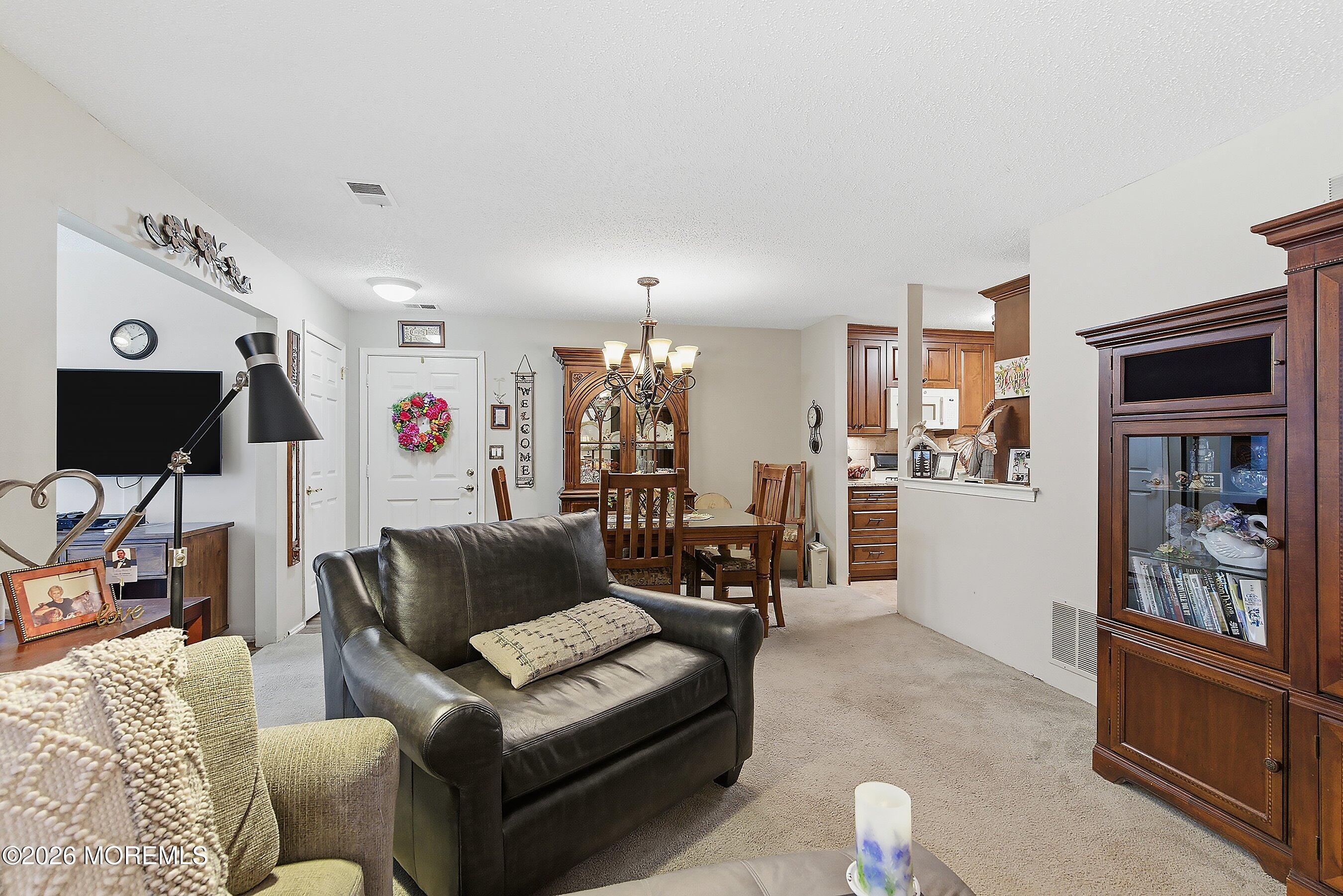 8-2 Seattle Court Freehold, NJ 07728 - Photo 11 of 35 a living room with furniture and a flat screen tv