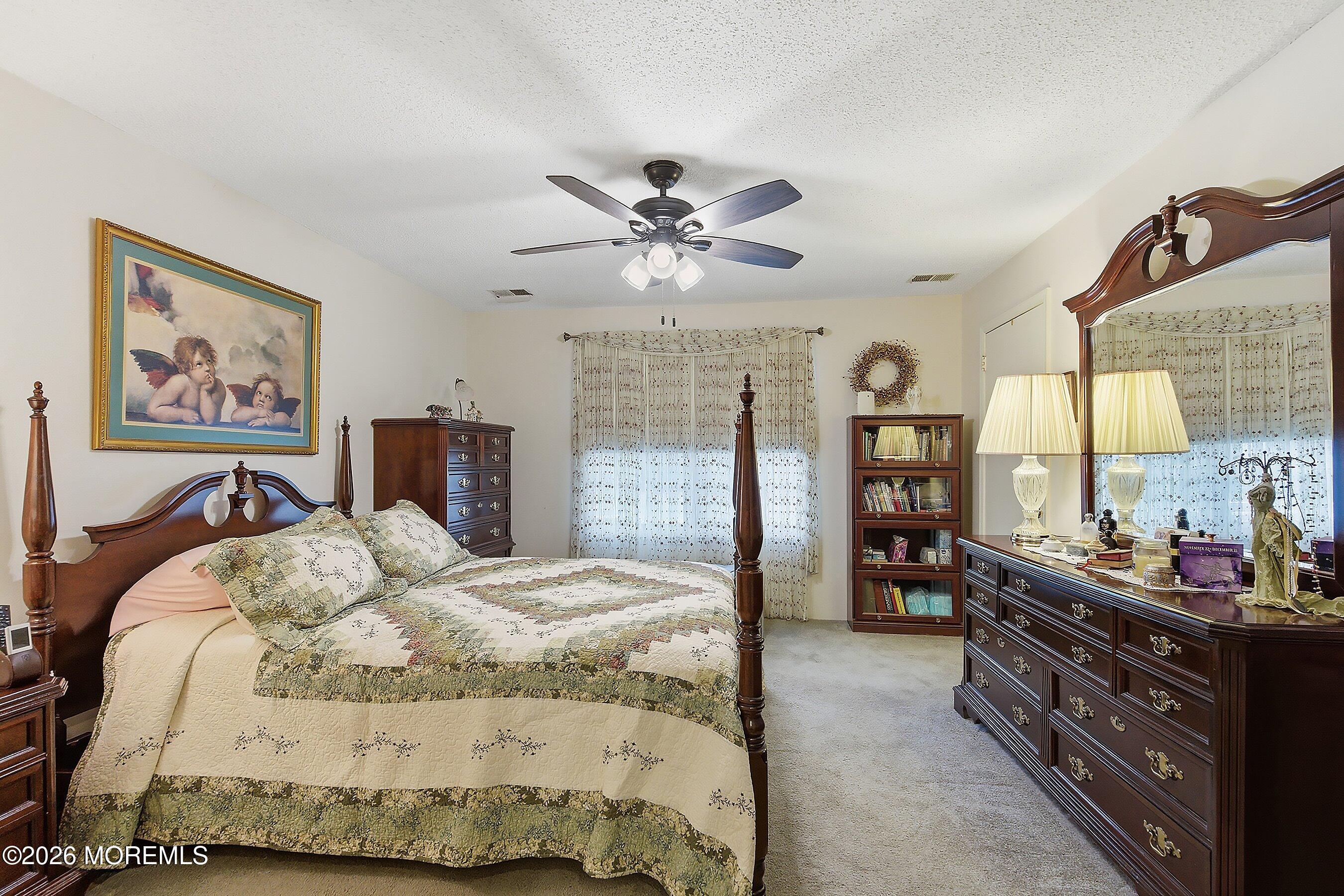 8-2 Seattle Court Freehold, NJ 07728 - Photo 16 of 35 a bed room with a bed and a chandelier