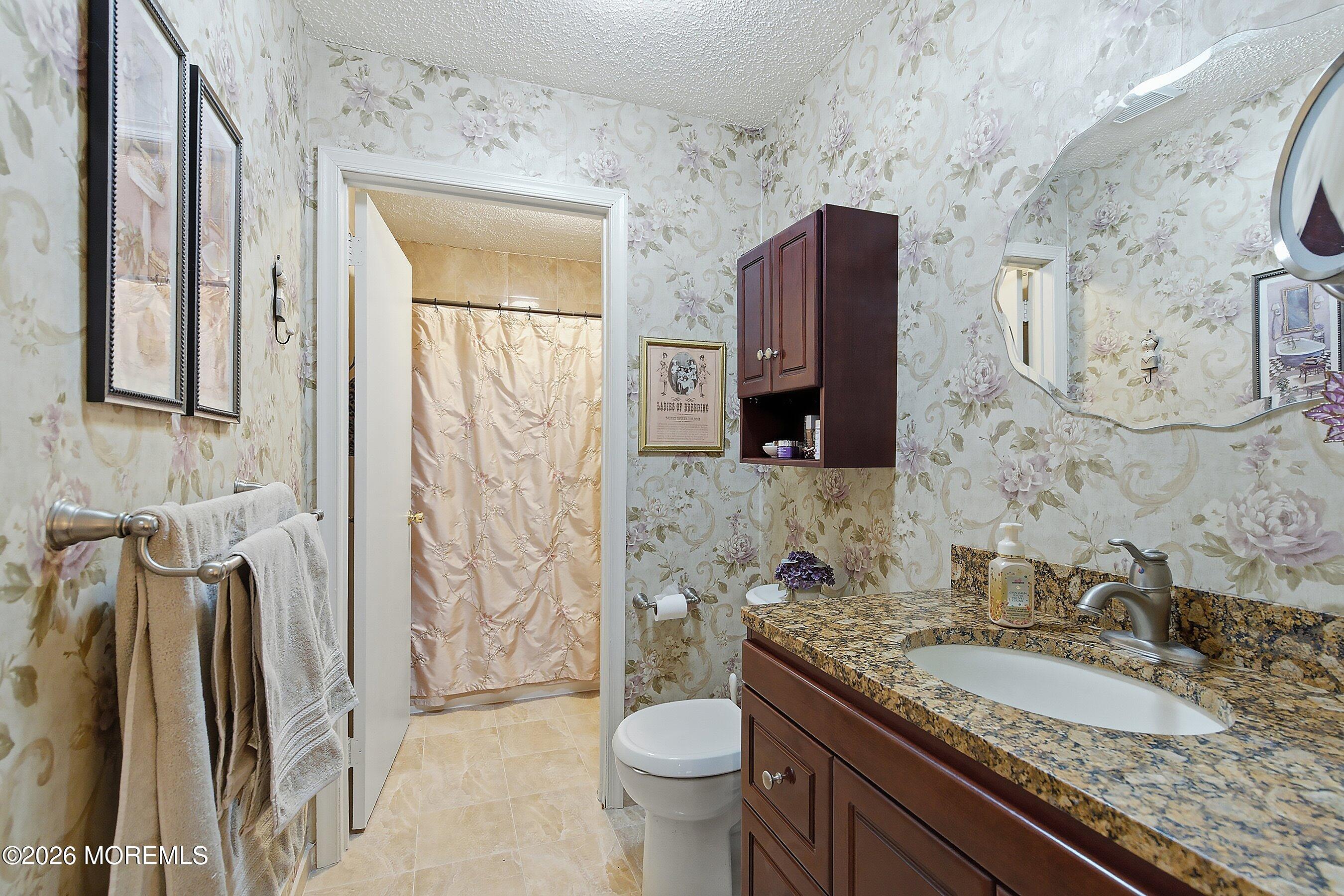 8-2 Seattle Court Freehold, NJ 07728 - Photo 17 of 35 a bathroom with a granite countertop sink toilet and shower