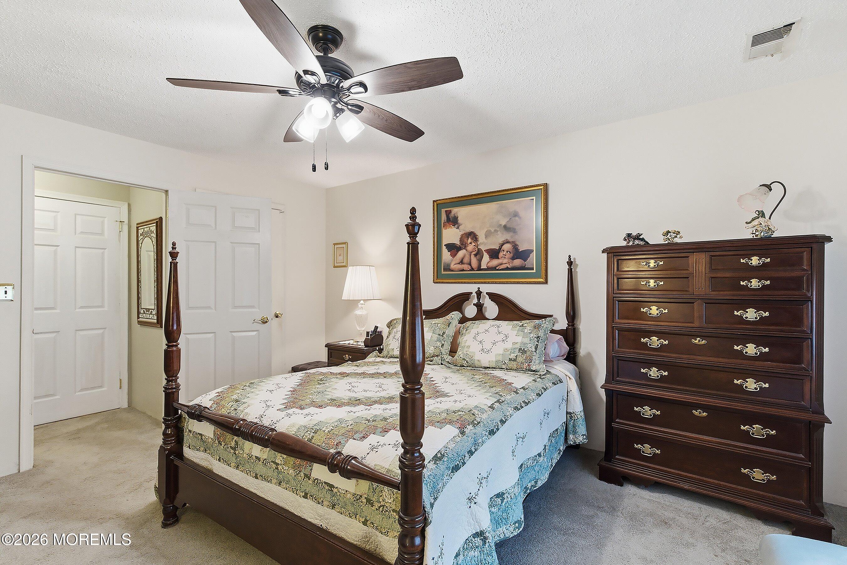 8-2 Seattle Court Freehold, NJ 07728 - Photo 18 of 35 a bedroom with a bed and a chandelier