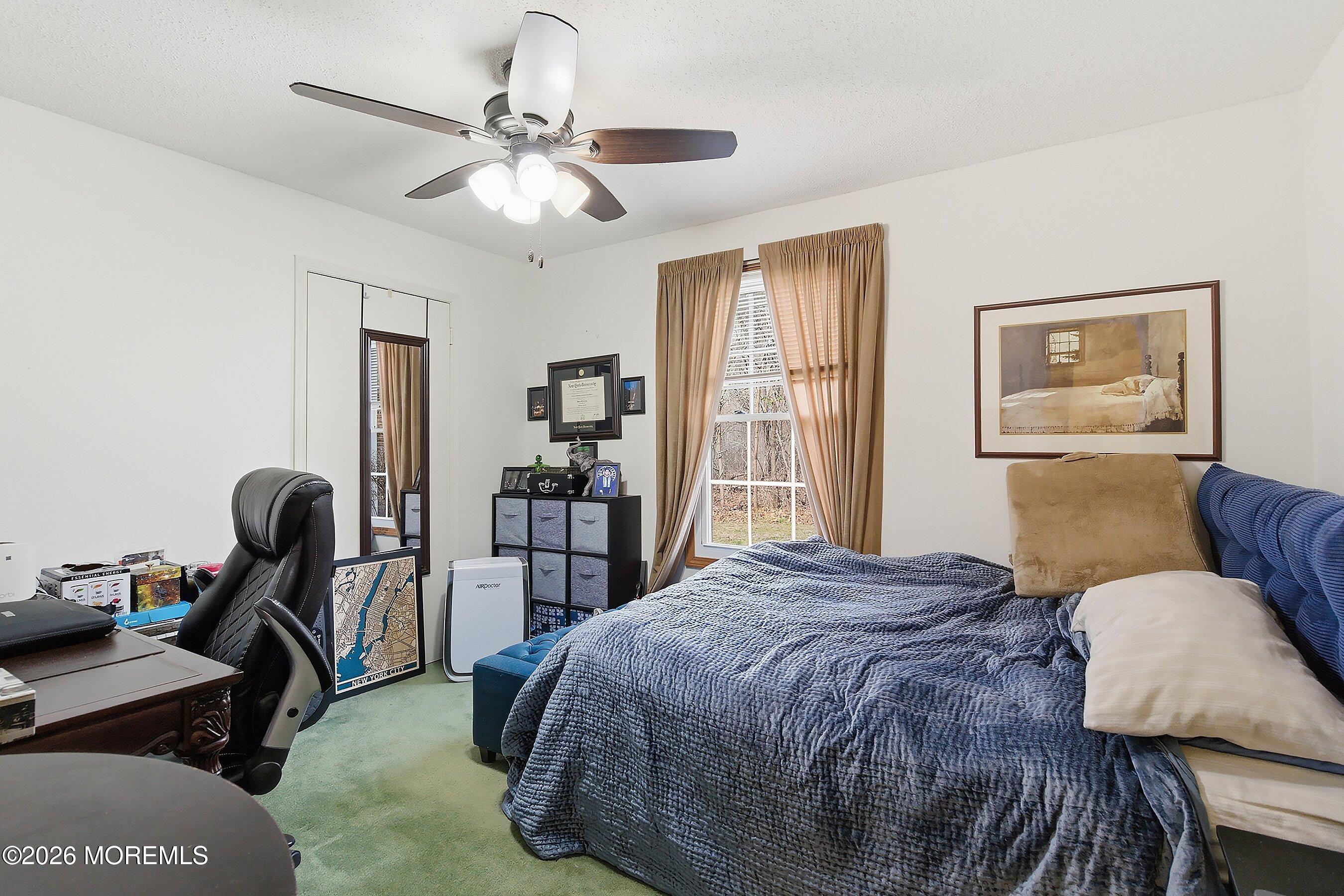 8-2 Seattle Court Freehold, NJ 07728 - Photo 20 of 35 a bedroom with a bed gym equipment and a window