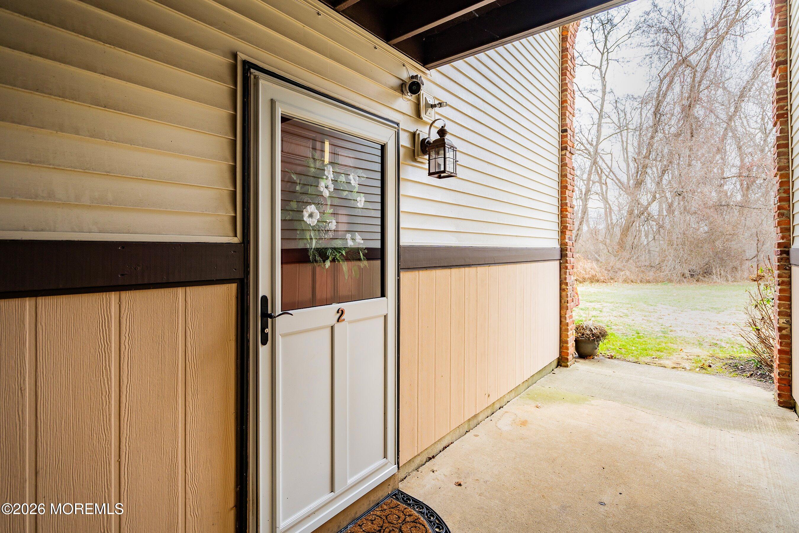 8-2 Seattle Court Freehold, NJ 07728 - Photo 2 of 35 a view of a porch with wooden floor