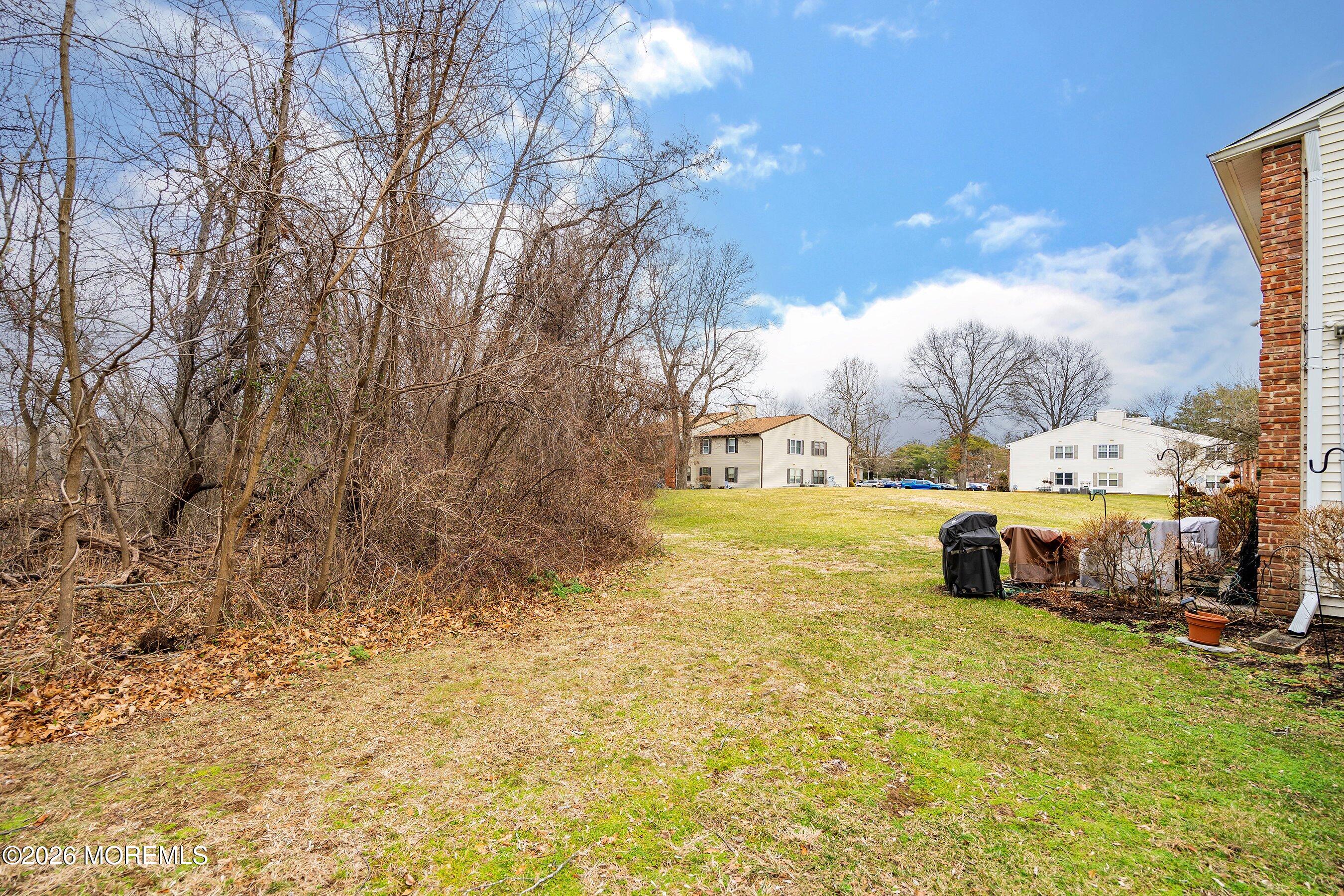 8-2 Seattle Court Freehold, NJ 07728 - Photo 24 of 35 a front view of a house with a yard