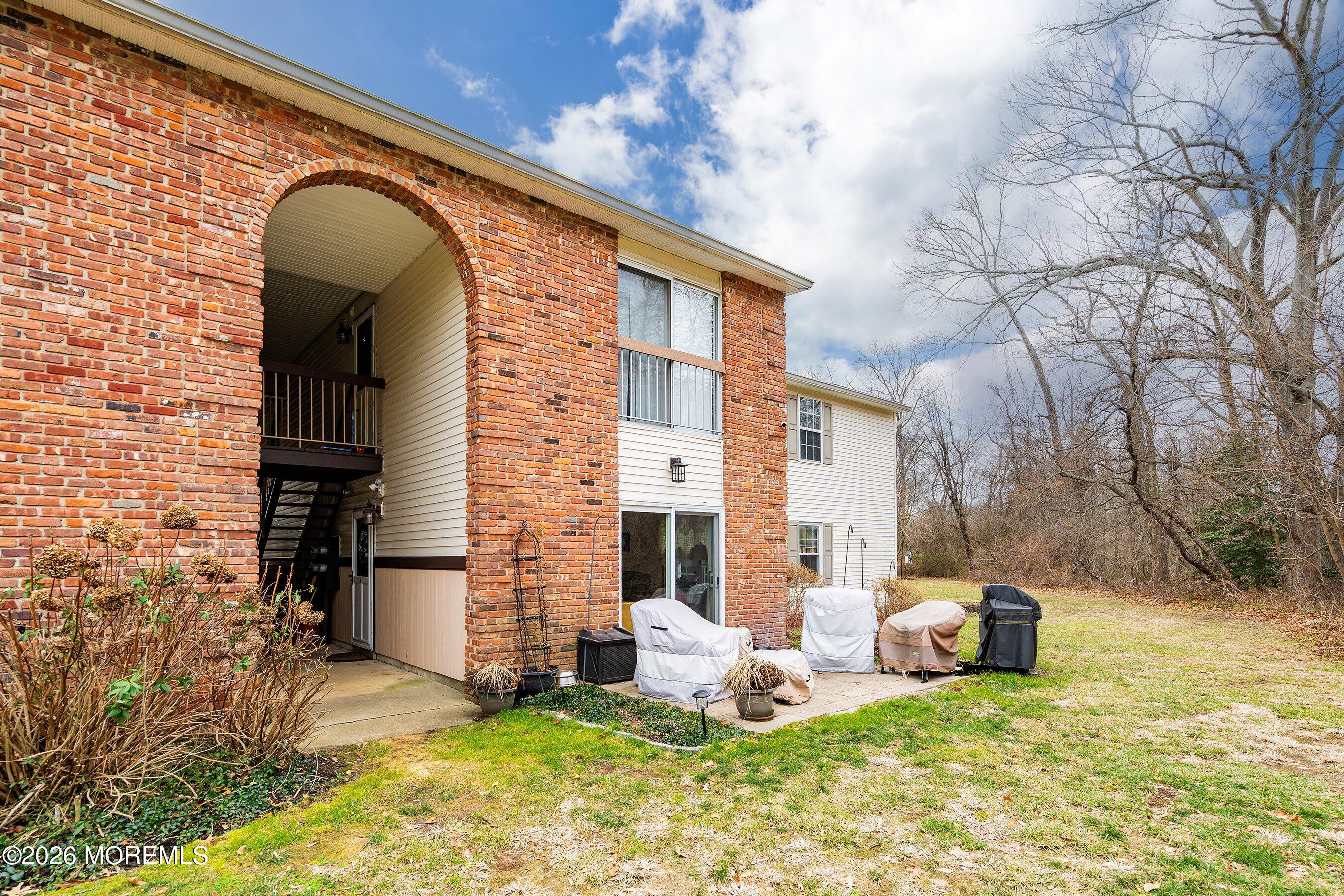 8-2 Seattle Court Freehold, NJ 07728 - Photo 25 of 35 a view of a house with backyard porch and sitting area