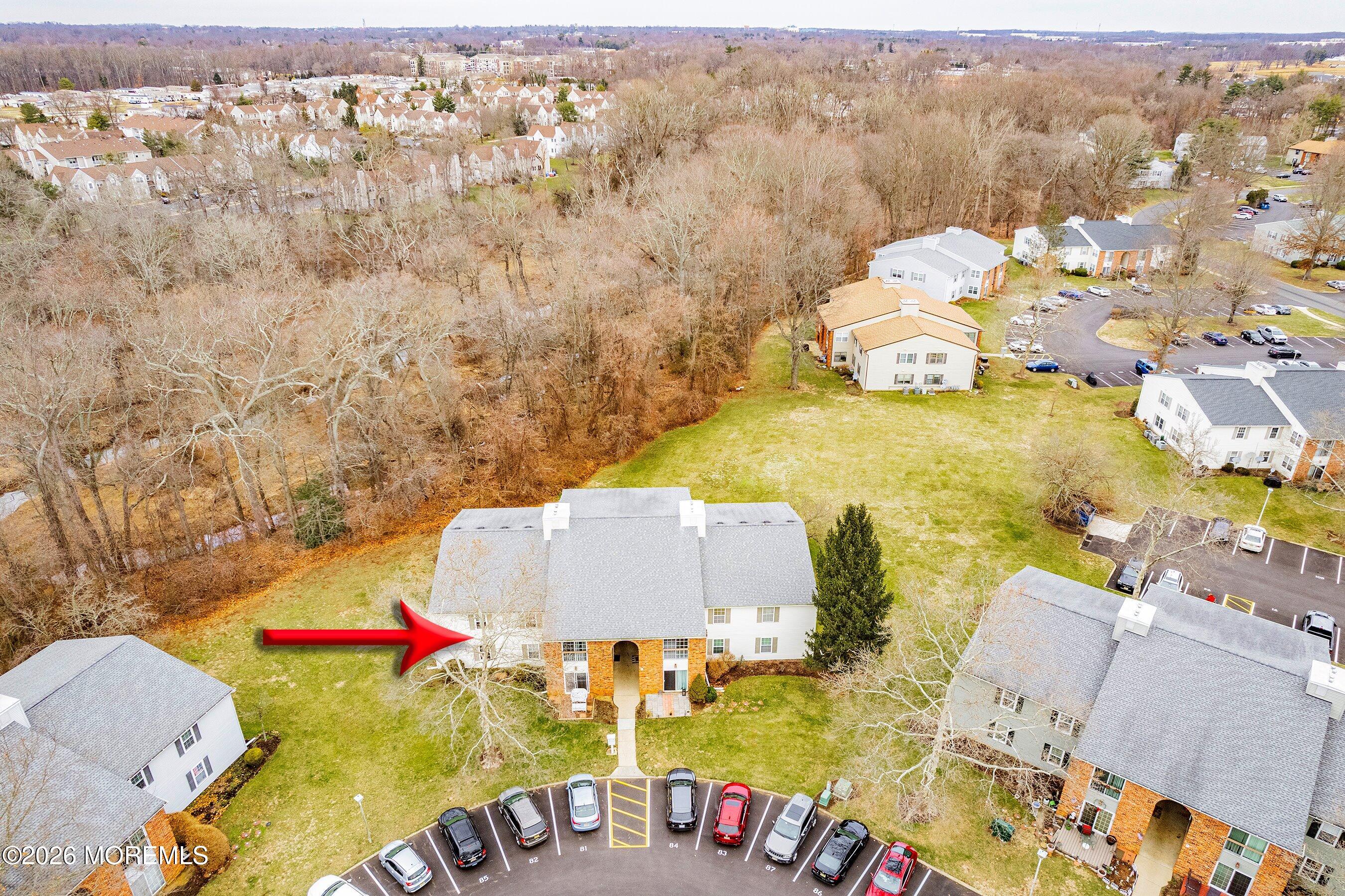 8-2 Seattle Court Freehold, NJ 07728 - Photo 29 of 35 an aerial view of a house with swimming pool and red umbrella