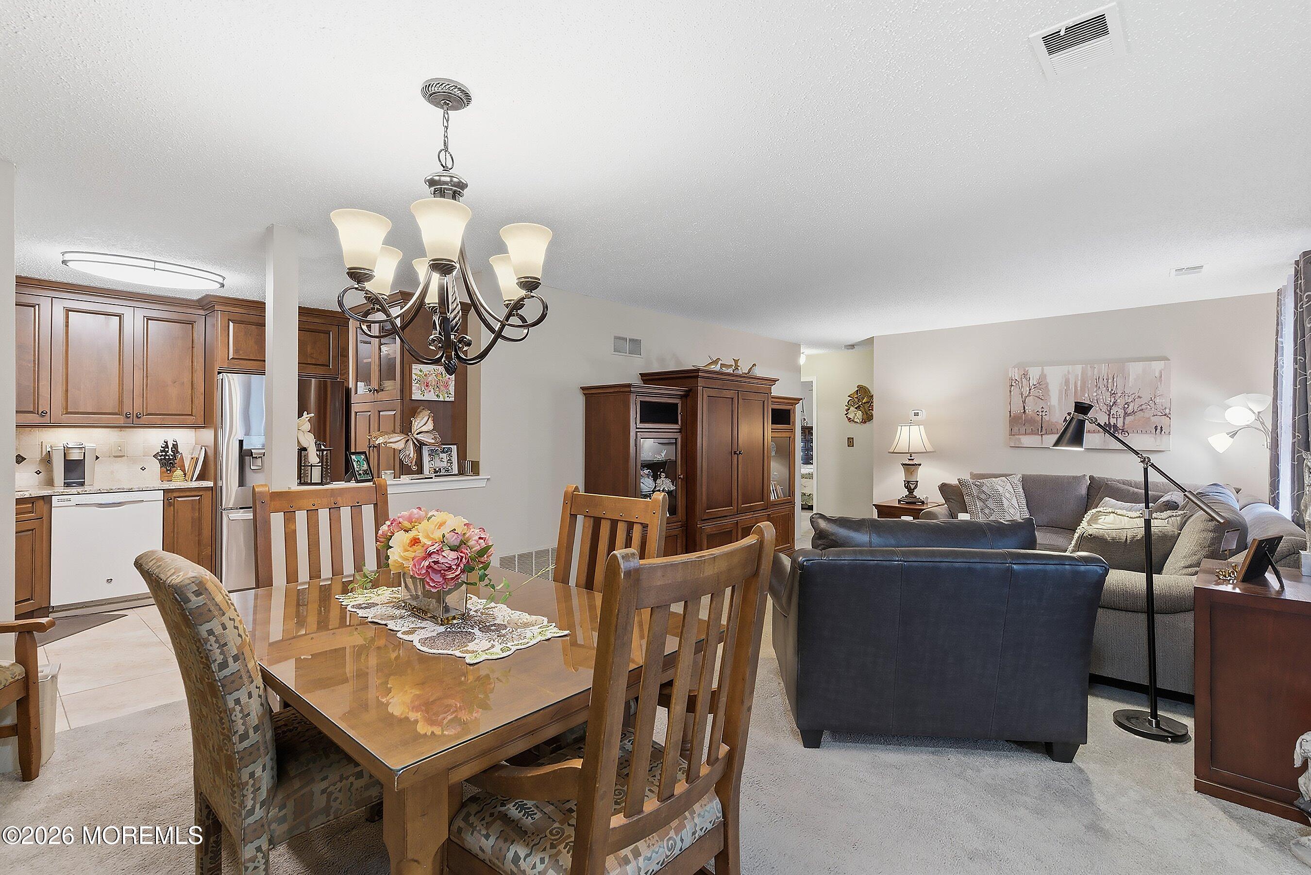 8-2 Seattle Court Freehold, NJ 07728 - Photo 4 of 35 a view of a dining room with furniture and chandelier