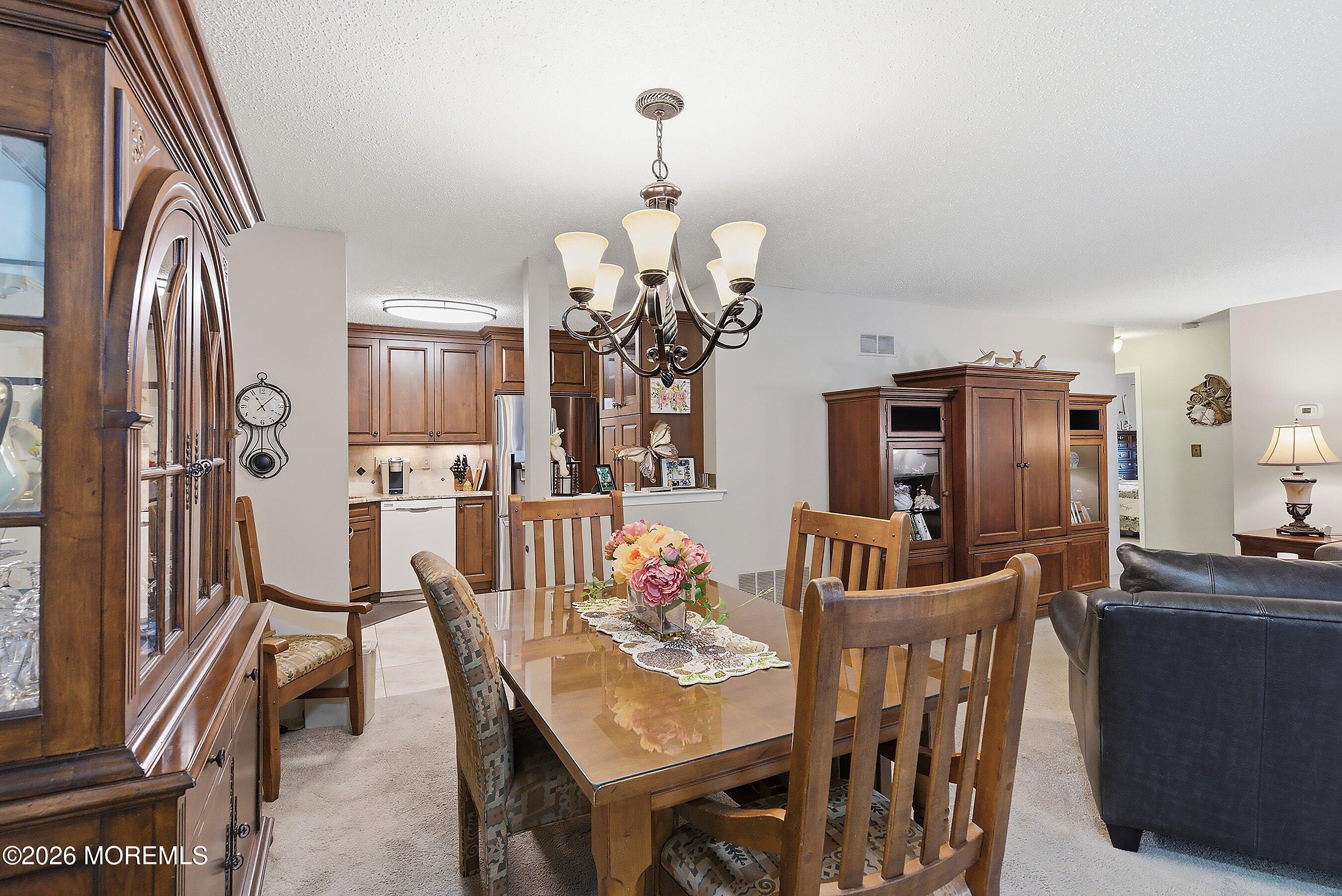 8-2 Seattle Court Freehold, NJ 07728 - Photo 5 of 35 a view of a dining room with furniture and a chandelier