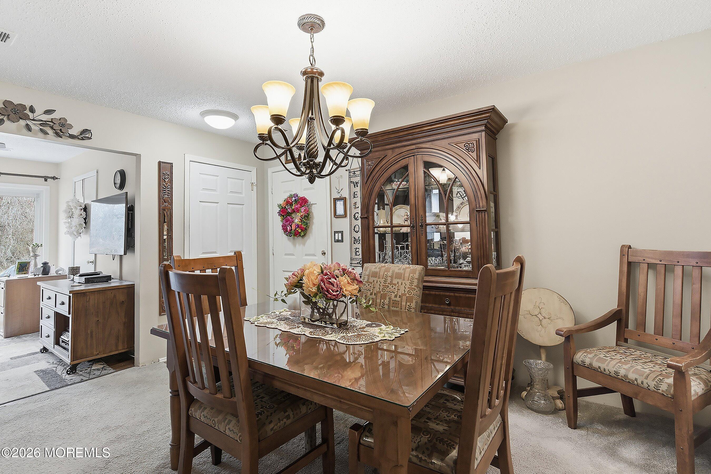 8-2 Seattle Court Freehold, NJ 07728 - Photo 6 of 35 a view of a dining room with furniture and chandelier