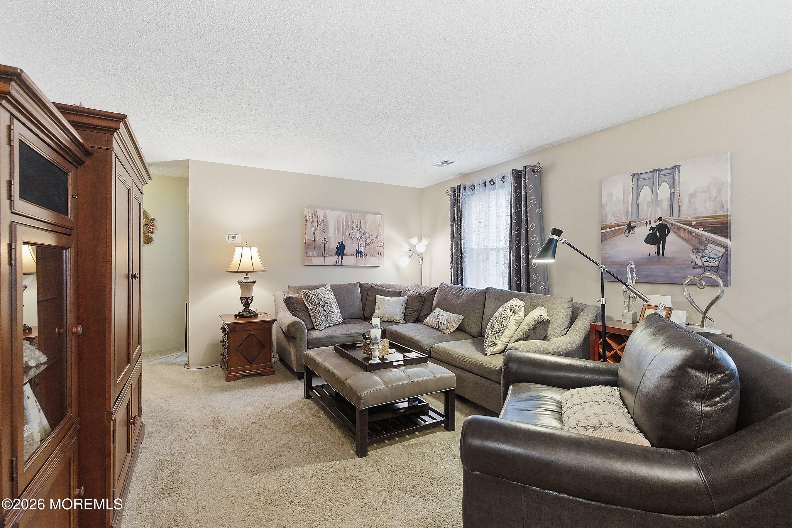 8-2 Seattle Court Freehold, NJ 07728 - Photo 9 of 35 a living room with furniture and a couch