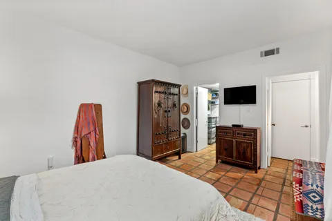 a bedroom with a bed and a television