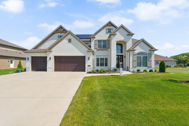 a front view of a house with a yard and porch