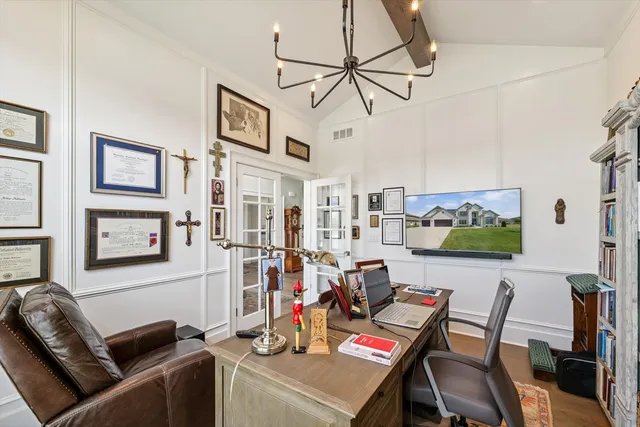 a view of a dining room with furniture large windows and wooden floor