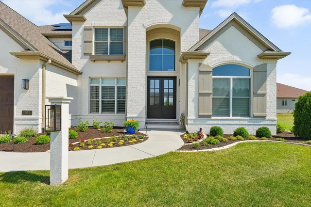 a front view of a house with garden
